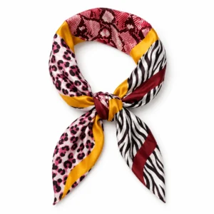 Foulard léopard bordeaux et rose à bandes dorées présenté avec un nœud central sur fond blanc